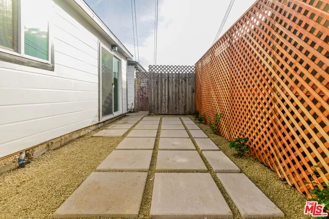 a view of wooden floor with a black white wall