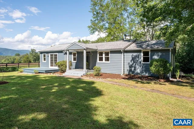 a front view of house with yard and green space