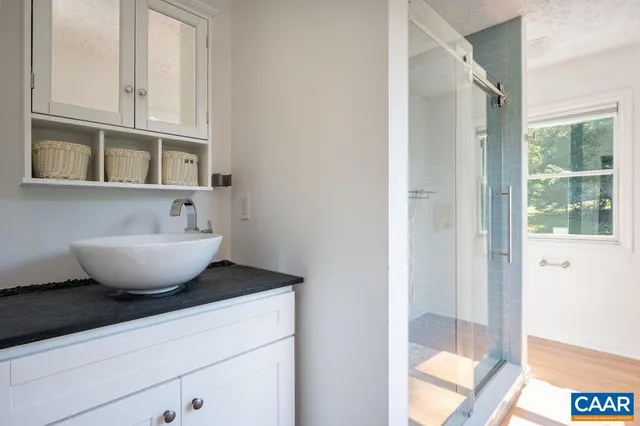 a view of a bathroom with a sink and mirror