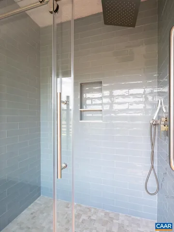 a bathroom with a glass shower door