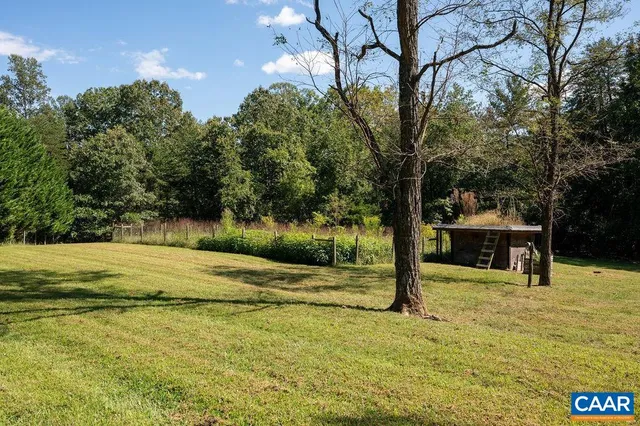 a view of a swimming pool with an outdoor seating and a yard