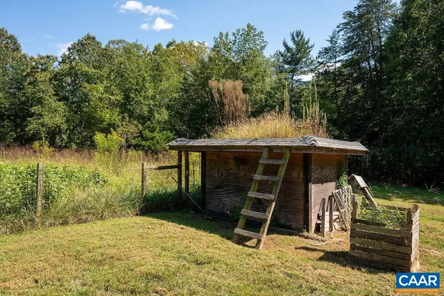 a view of a wooden deck and a yard with trees