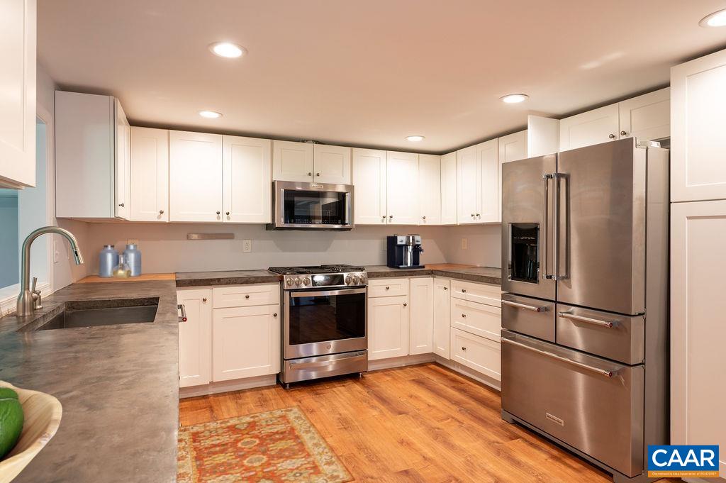 8165 Open Gate Lane Afton, VA 22920 - Photo 10 of 39 a kitchen with stainless steel appliances granite countertop a refrigerator sink and stove