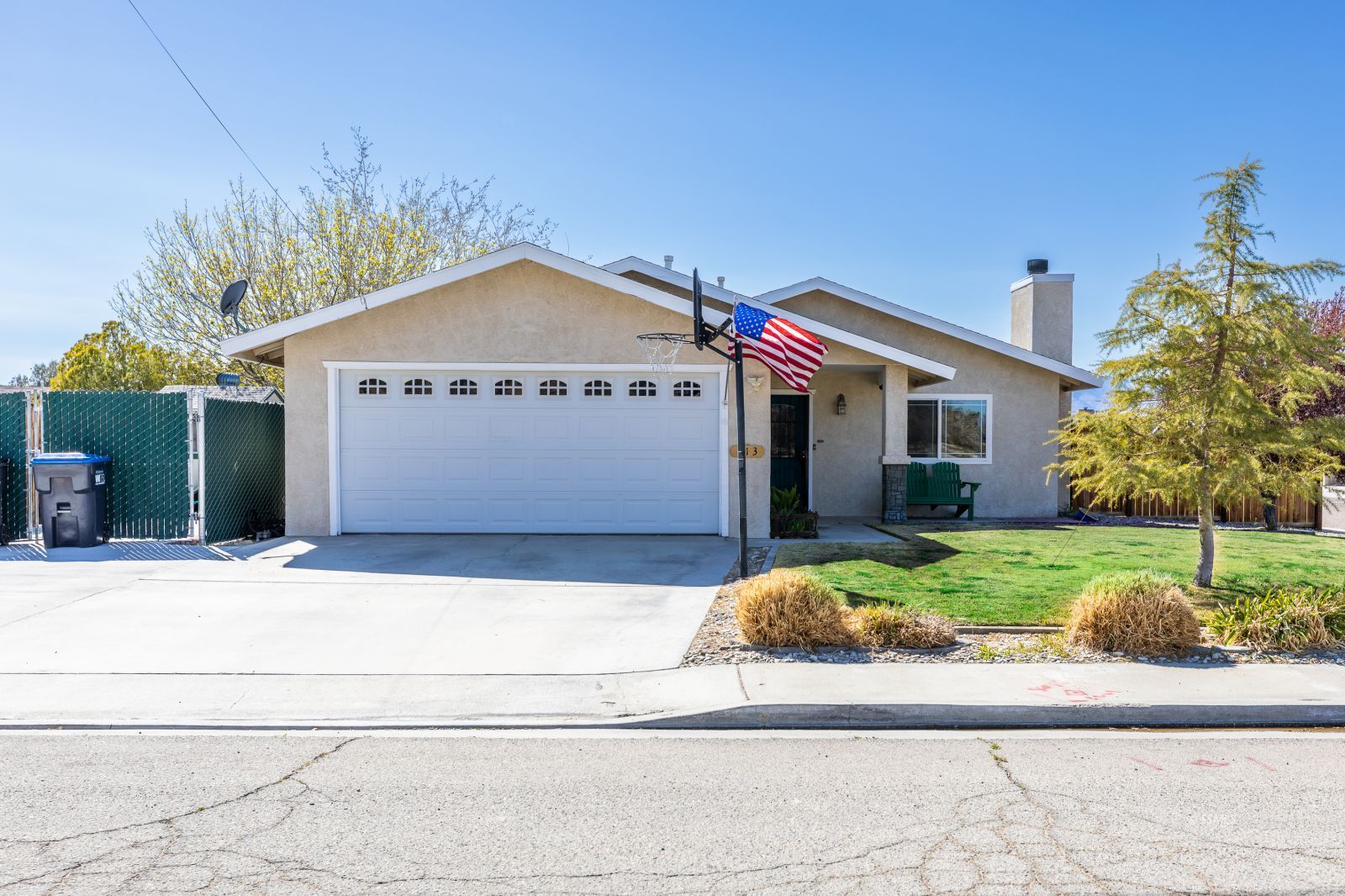 413 North Inyo Street Ridgecrest, CA 93555 - Photo 1 of 27 a front view of a house with a yard and garage