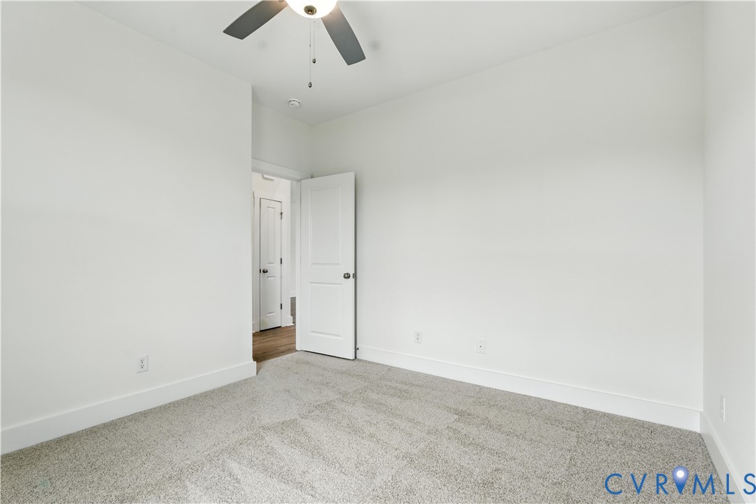 5782 Darlington Heights Road Cullen, VA 23934 - Photo 16 of 21 an empty room with chandelier fan and kitchen view