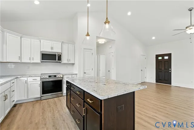 a large kitchen with granite countertop a stove and a sink