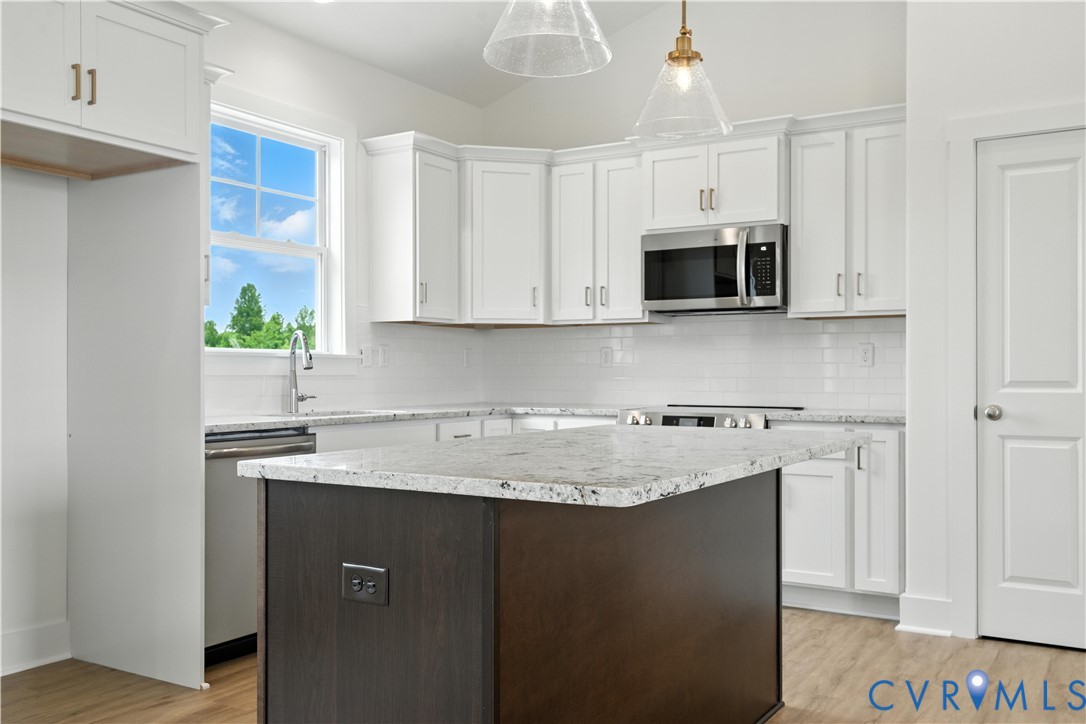 5782 Darlington Heights Road Cullen, VA 23934 - Photo 8 of 21 a kitchen with stainless steel appliances granite countertop a sink stove and microwave