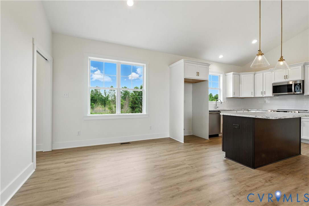 5782 Darlington Heights Road Cullen, VA 23934 - Photo 10 of 21 a kitchen with stainless steel appliances granite countertop a stove a sink and a refrigerator