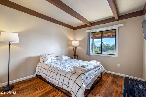 a bedroom with a bed and a window