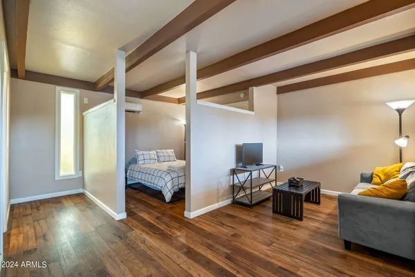 a living room with furniture and wooden floor
