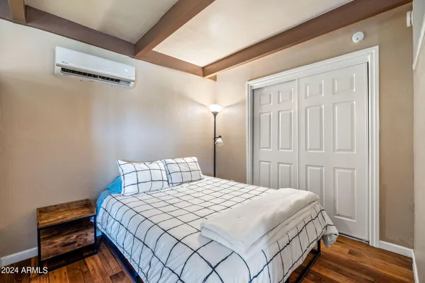 a bedroom with a bed and a window