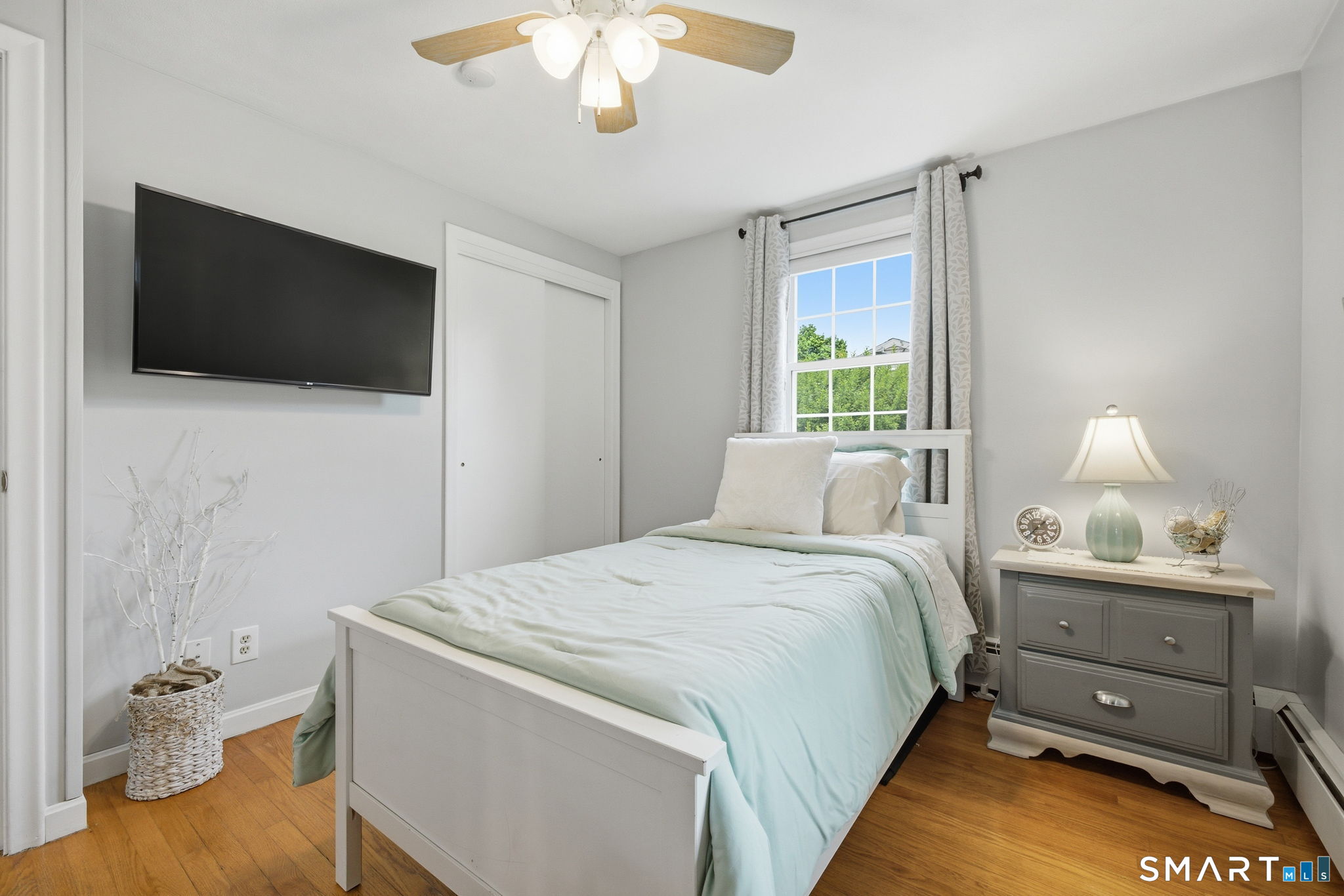 7 Stardust Drive Enfield, CT 06082 - Photo 16 of 38 a bedroom with a bed and a flat screen tv