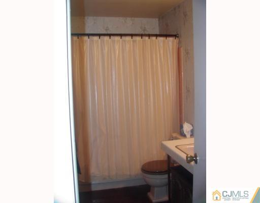 4 Newkirk Road Somerset, NJ 08873 - Photo 7 of 10 a bathroom with a granite countertop sink and a toilet