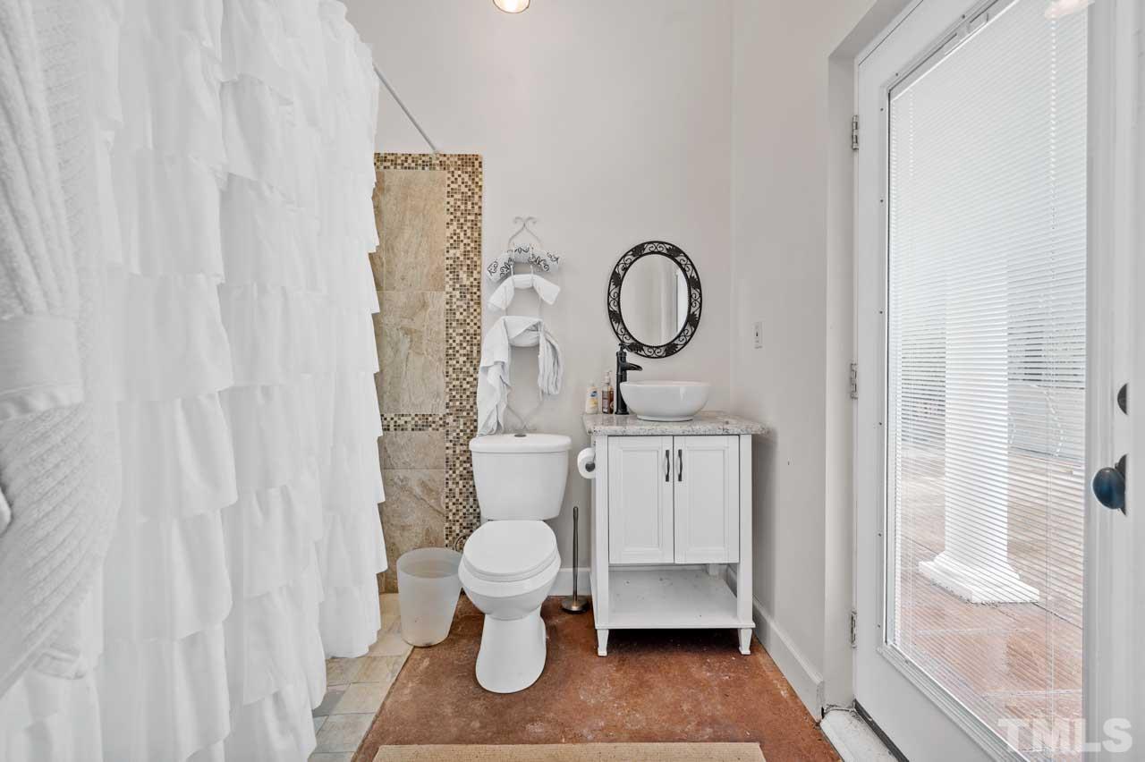 1605 Sharnbrook Court Raleigh, NC 27614 - Photo 14 of 63 a bathroom with a toilet a sink and a shower curtain