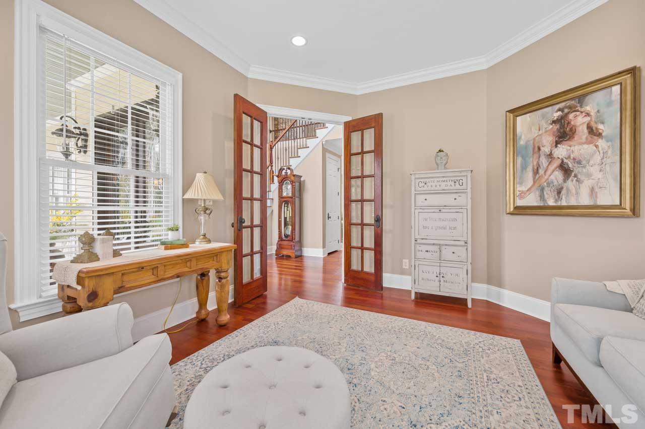 1605 Sharnbrook Court Raleigh, NC 27614 - Photo 17 of 63 a living room with furniture a rug and a large window