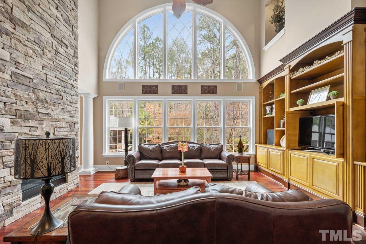 1605 Sharnbrook Court Raleigh, NC 27614 - Photo 23 of 63 a living room with furniture fireplace and large windows