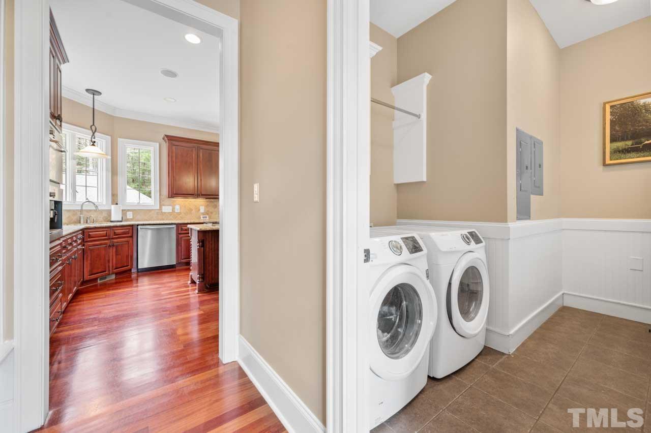 1605 Sharnbrook Court Raleigh, NC 27614 - Photo 32 of 63 a view of washer and dryer with bathroom in the background