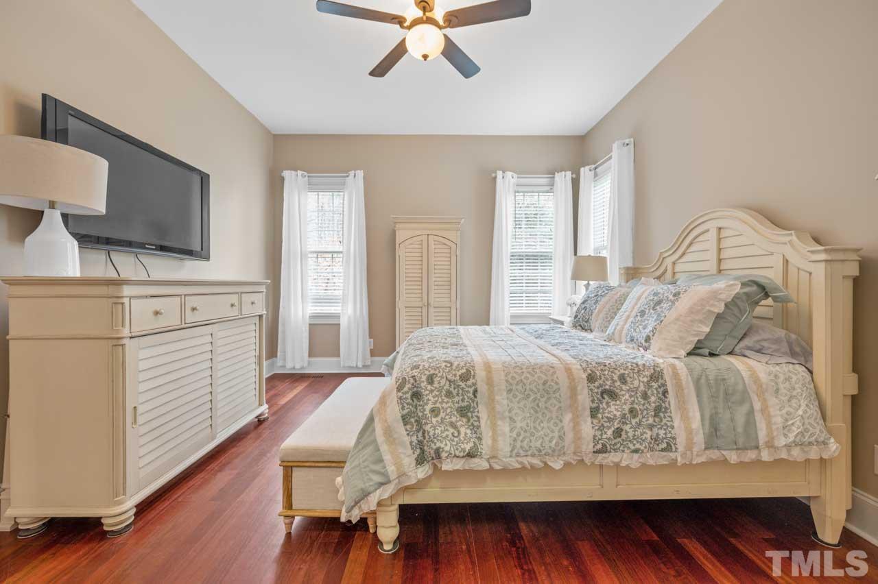 1605 Sharnbrook Court Raleigh, NC 27614 - Photo 34 of 63 a bedroom with a bed and a flat screen tv