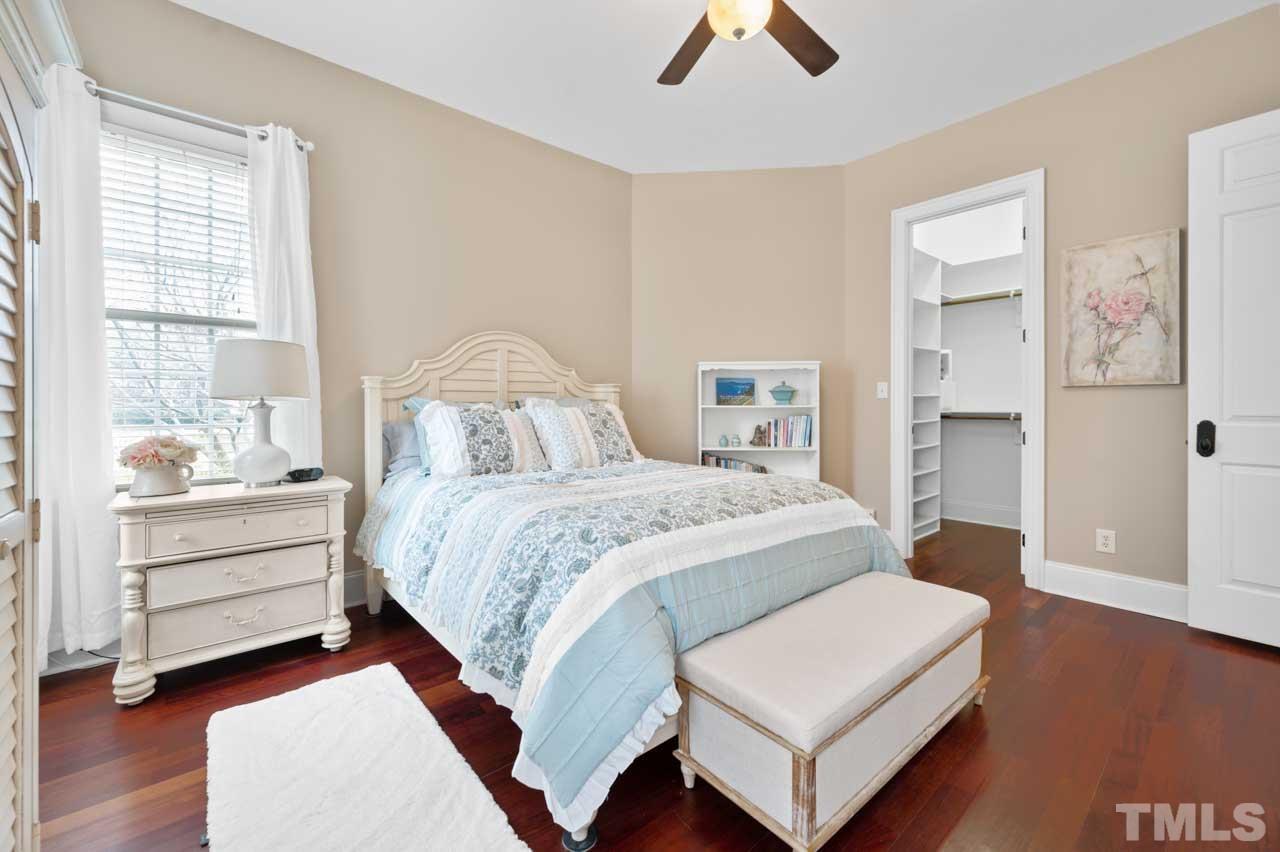 1605 Sharnbrook Court Raleigh, NC 27614 - Photo 35 of 63 a bedroom with a bed and a chandelier