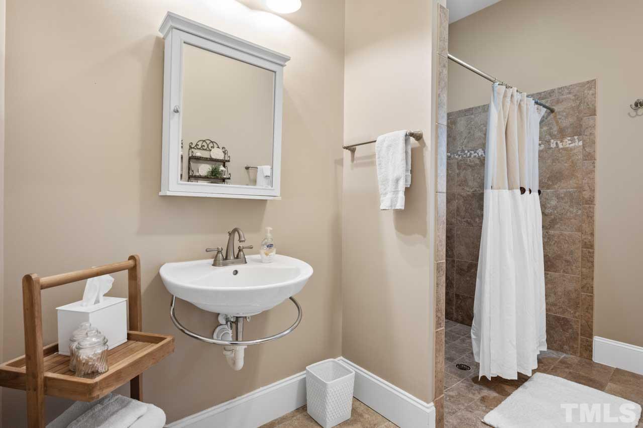 1605 Sharnbrook Court Raleigh, NC 27614 - Photo 36 of 63 a bathroom with a sink and a mirror