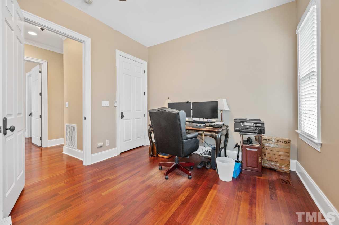 1605 Sharnbrook Court Raleigh, NC 27614 - Photo 38 of 63 a view of a workspace with furniture and wooden floor