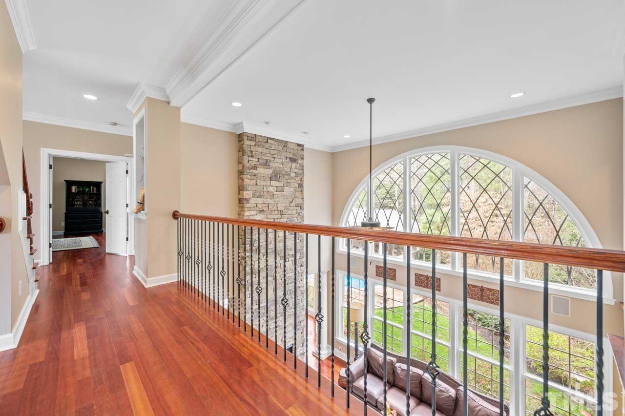 1605 Sharnbrook Court Raleigh, NC 27614 - Photo 40 of 63 a view of hallway with a large window and wooden floor