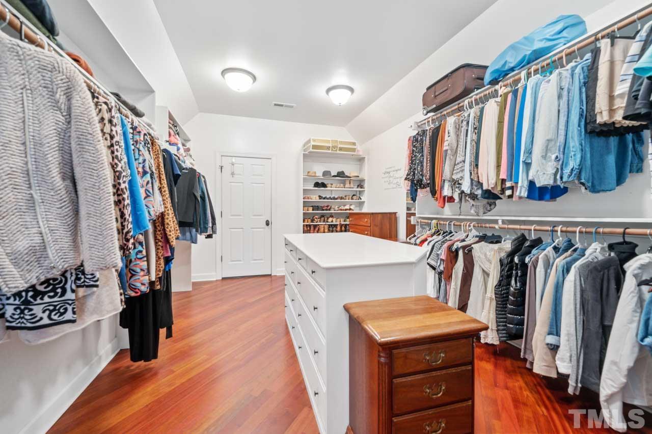 1605 Sharnbrook Court Raleigh, NC 27614 - Photo 49 of 63 a view of walk in closet with clothes and shoes