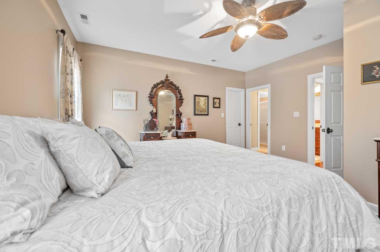 1605 Sharnbrook Court Raleigh, NC 27614 - Photo 51 of 63 a bedroom with a bed and a chandelier