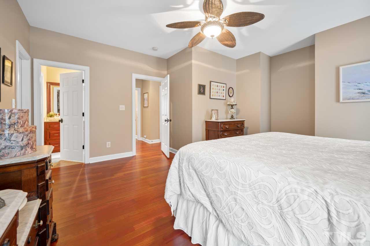 1605 Sharnbrook Court Raleigh, NC 27614 - Photo 52 of 63 a bedroom with a large bed and chandelier