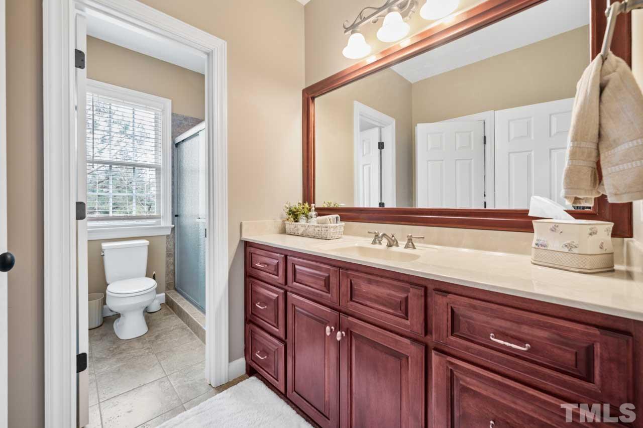 1605 Sharnbrook Court Raleigh, NC 27614 - Photo 53 of 63 a bathroom with a sink a toilet and a mirror