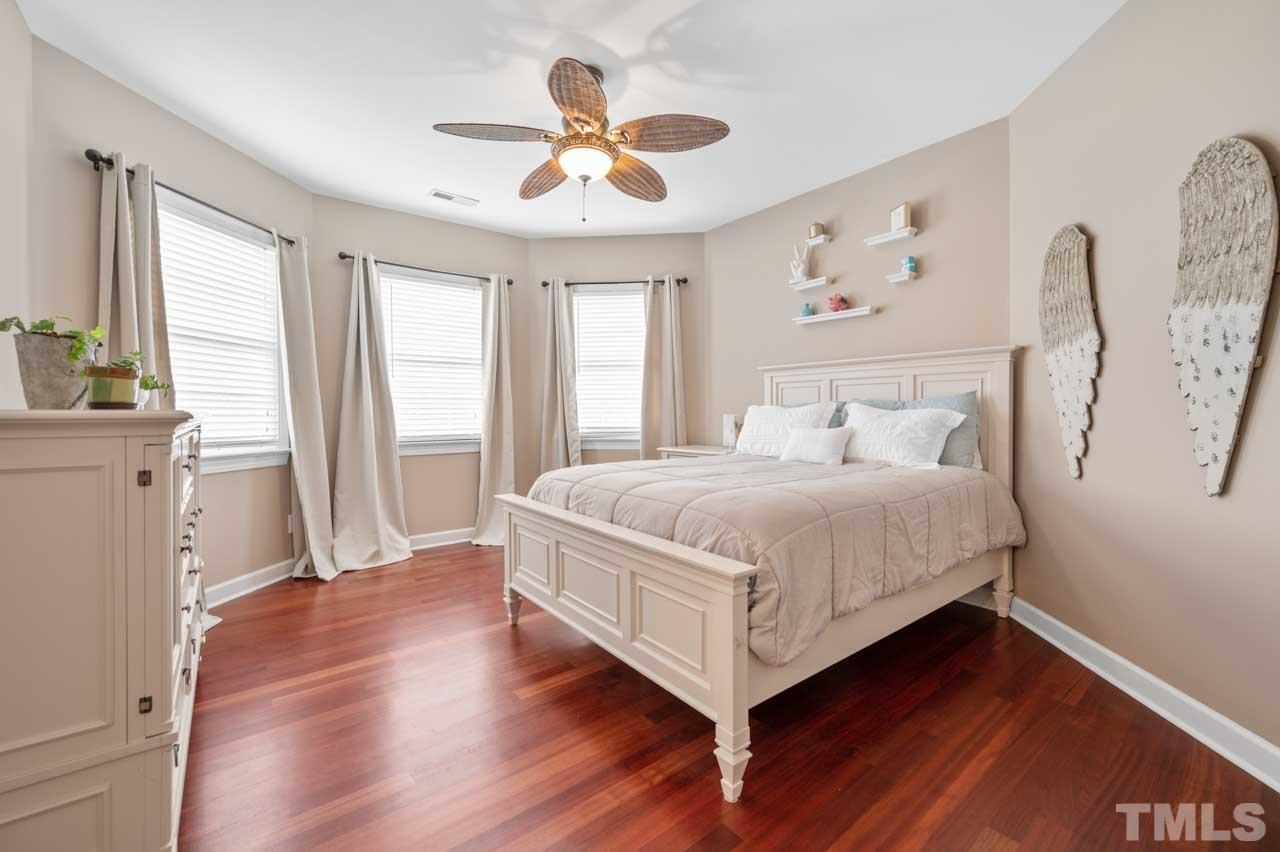 1605 Sharnbrook Court Raleigh, NC 27614 - Photo 54 of 63 a bedroom with a large bed and a large window