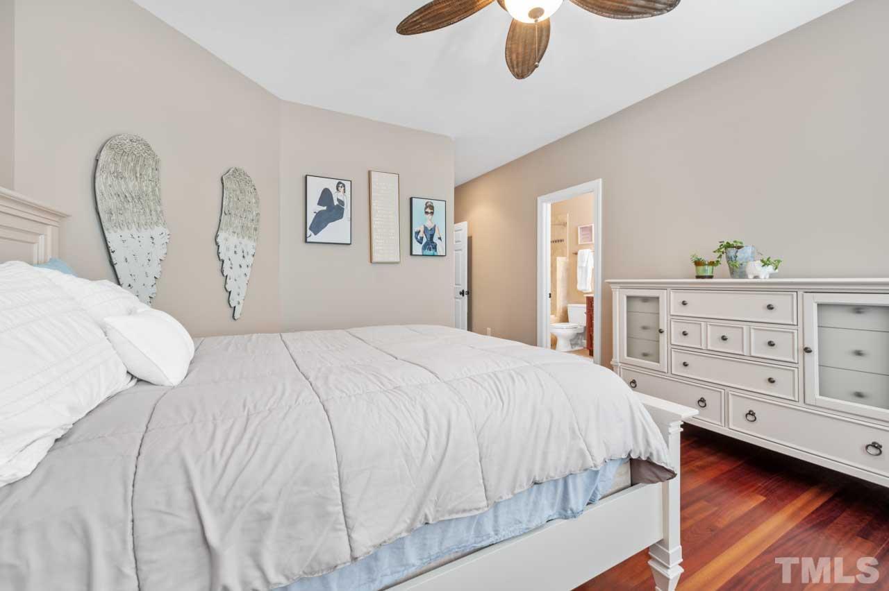 1605 Sharnbrook Court Raleigh, NC 27614 - Photo 55 of 63 a bedroom with a large bed and a chandelier