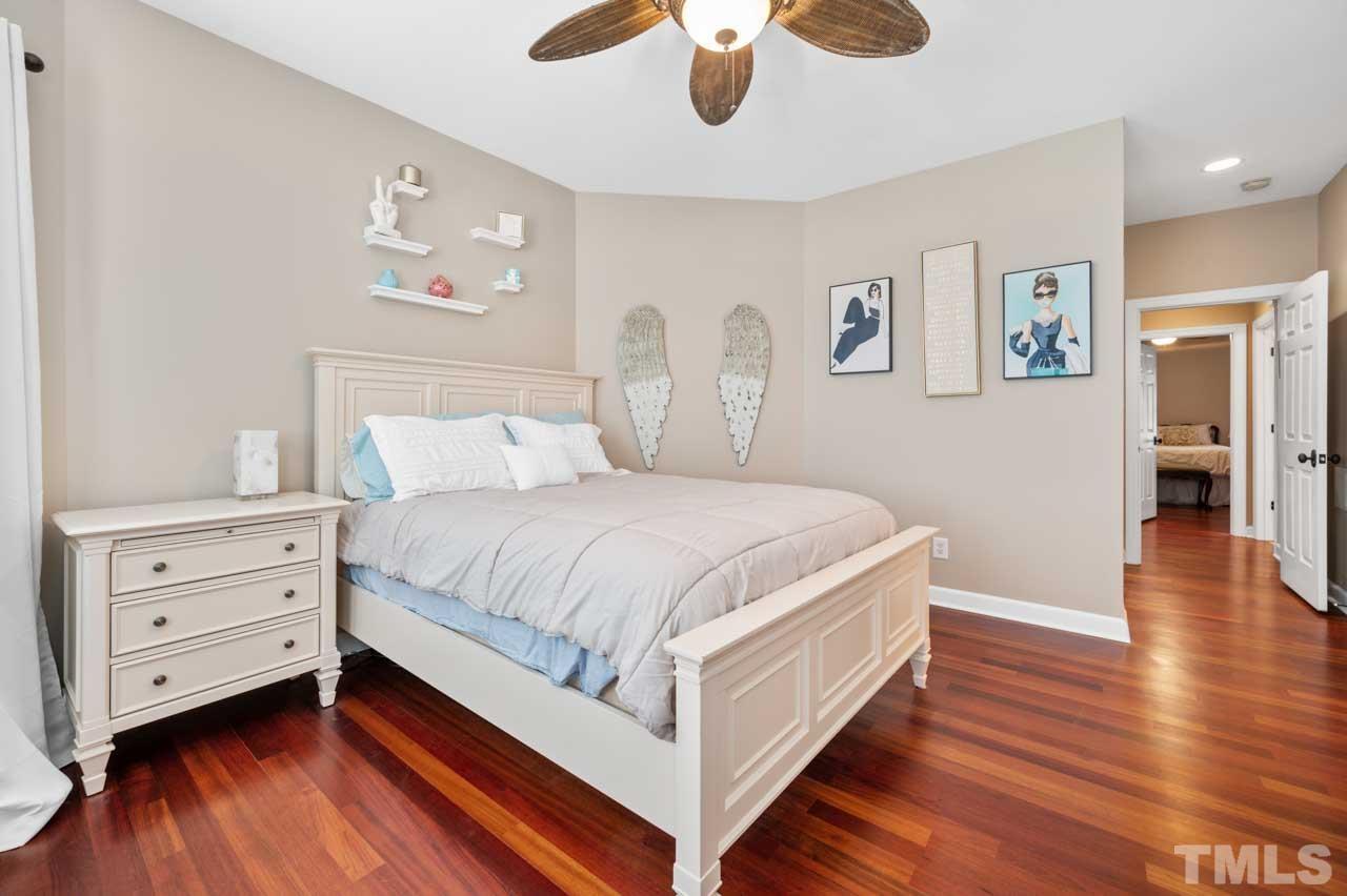 1605 Sharnbrook Court Raleigh, NC 27614 - Photo 56 of 63 a spacious bedroom with a bed and a chandelier