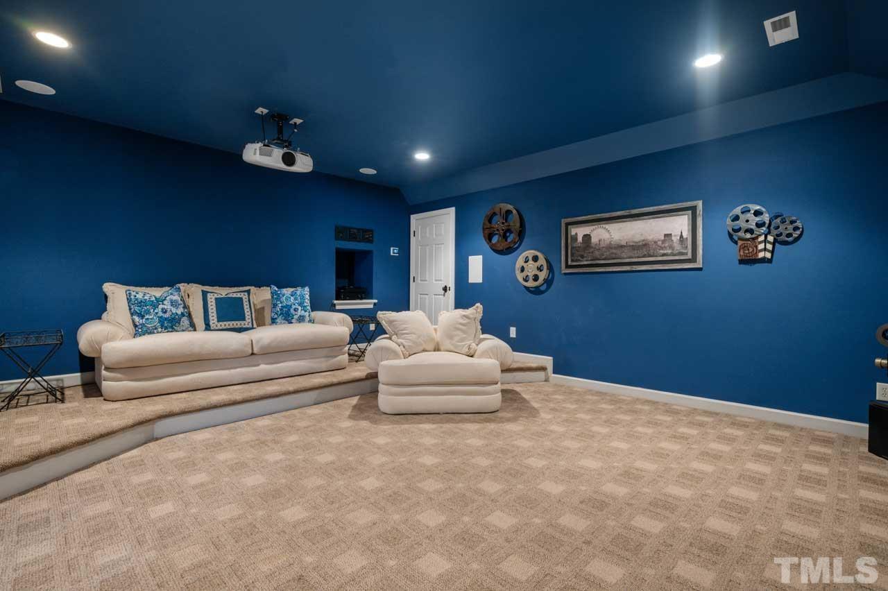 1605 Sharnbrook Court Raleigh, NC 27614 - Photo 62 of 63 a spacious bedroom with a bed and a couch