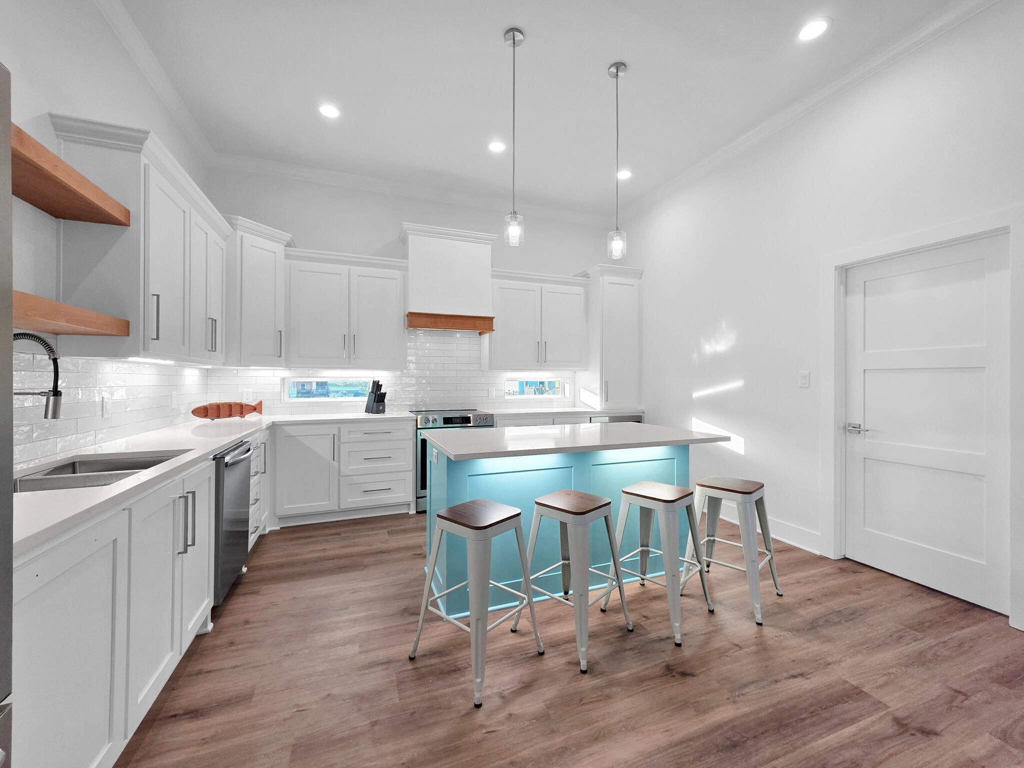 1221 Gulf Road Crystal Beach, TX 77650 - Photo 13 of 48 a kitchen with a sink cabinets and wooden floor