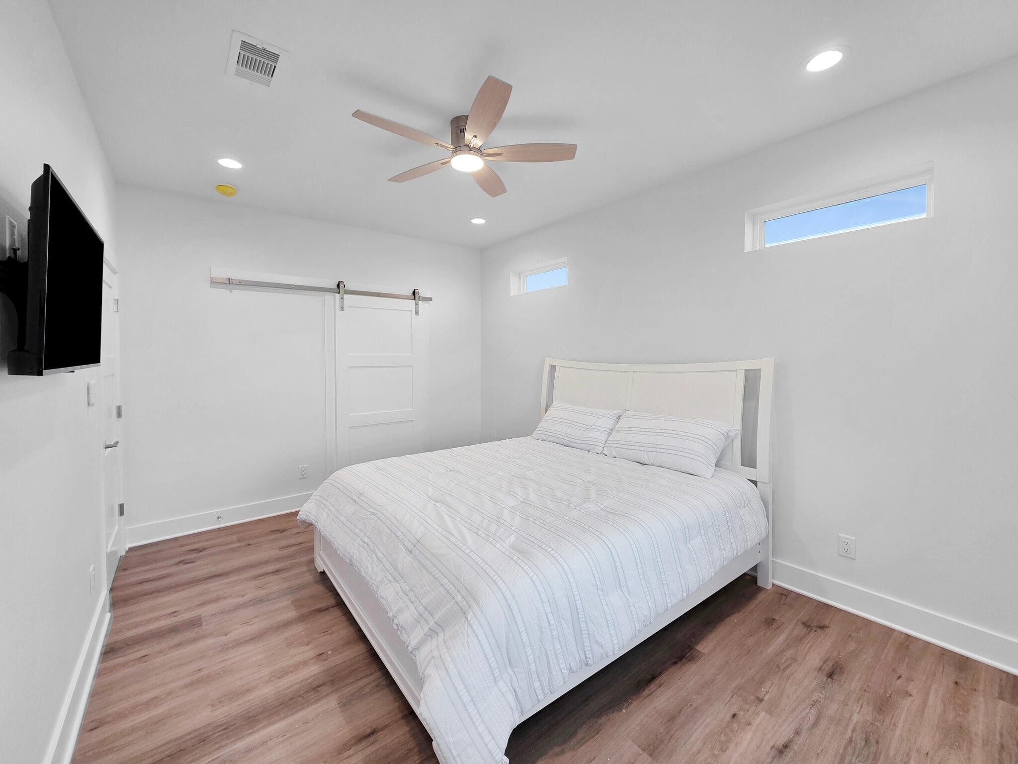 1221 Gulf Road Crystal Beach, TX 77650 - Photo 22 of 48 a bedroom with a bed and a flat screen tv