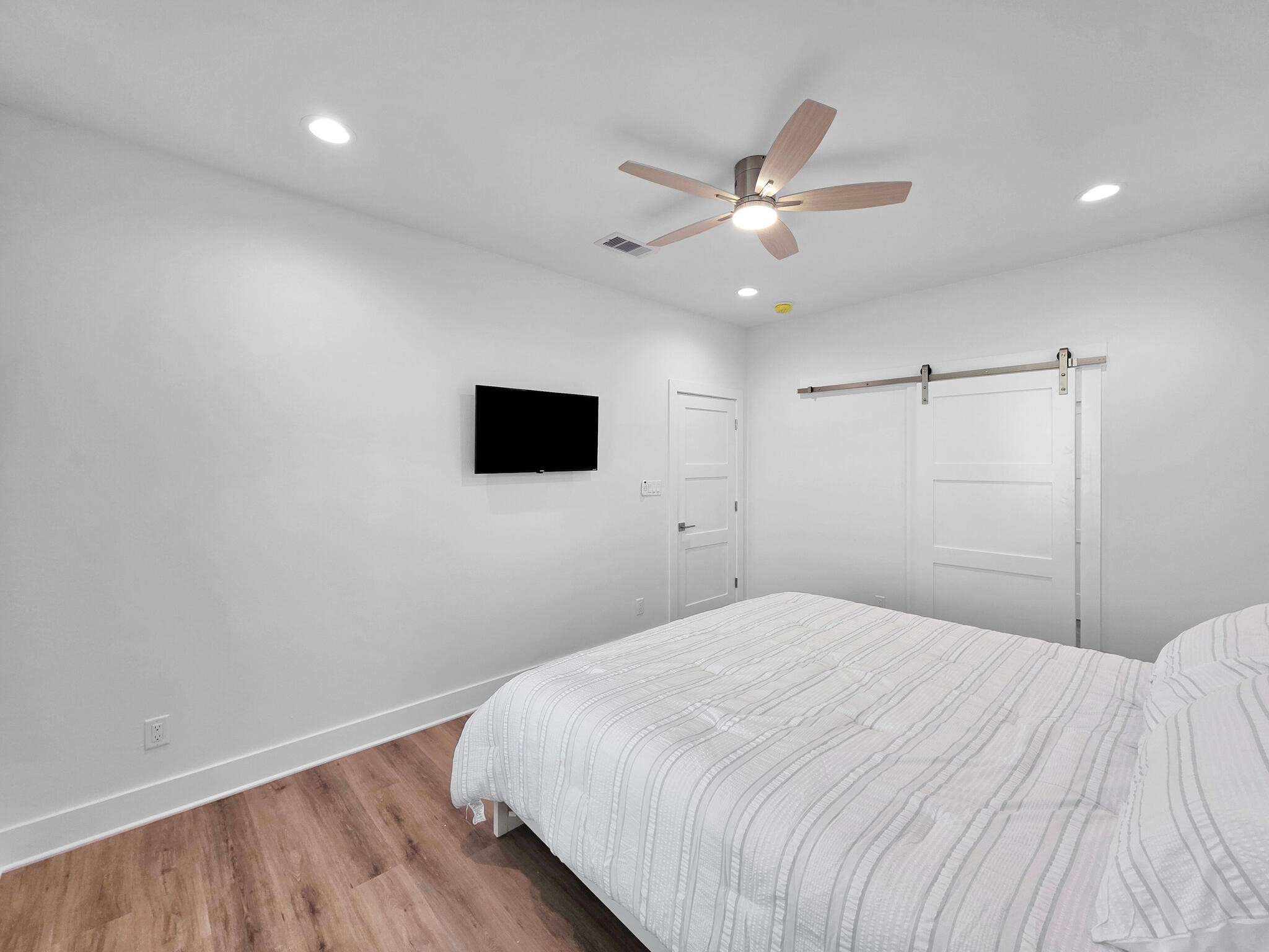 1221 Gulf Road Crystal Beach, TX 77650 - Photo 23 of 48 a bedroom with a bed and a flat screen tv