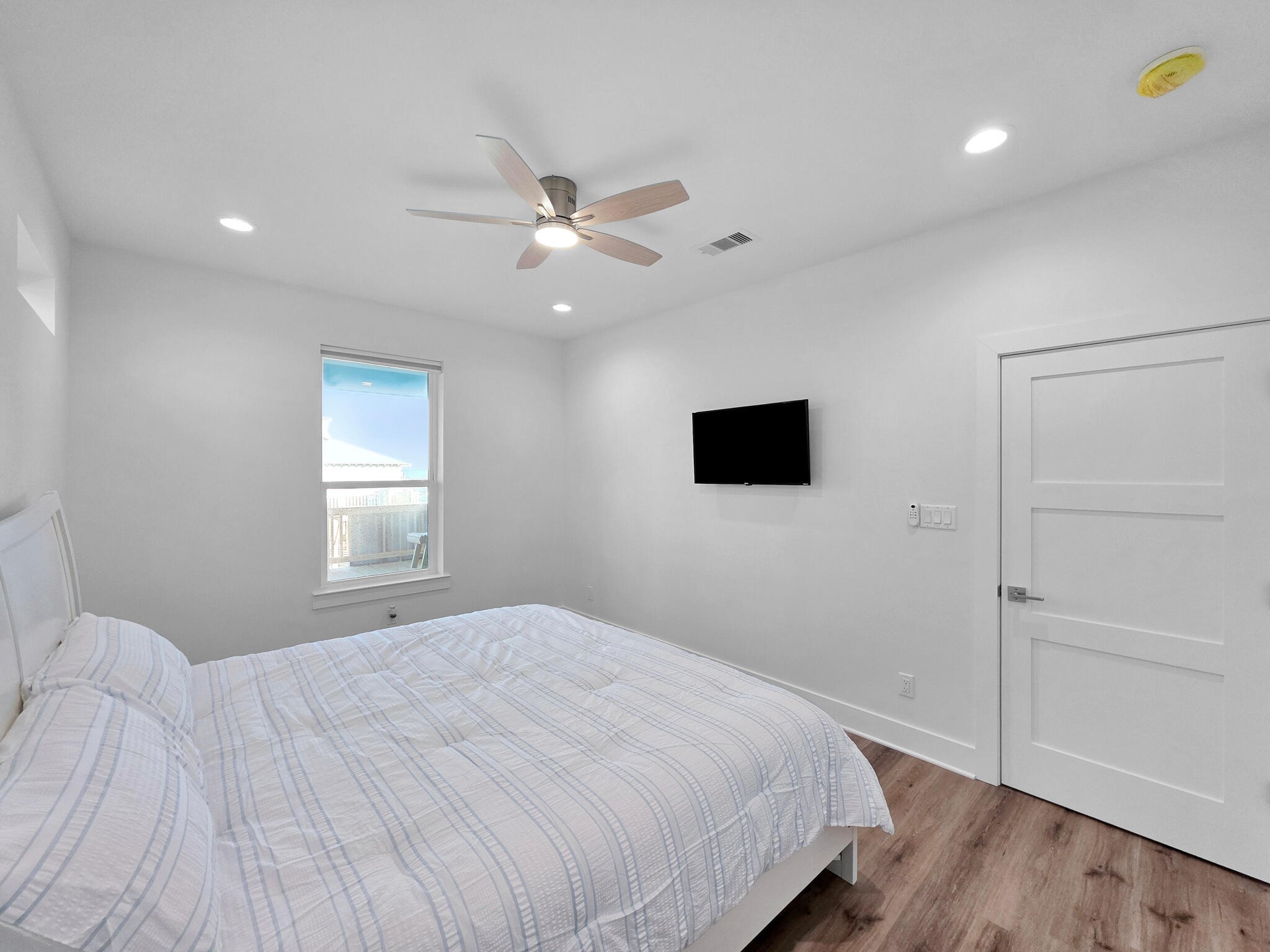 1221 Gulf Road Crystal Beach, TX 77650 - Photo 24 of 48 a bedroom with a bed and a flat screen tv