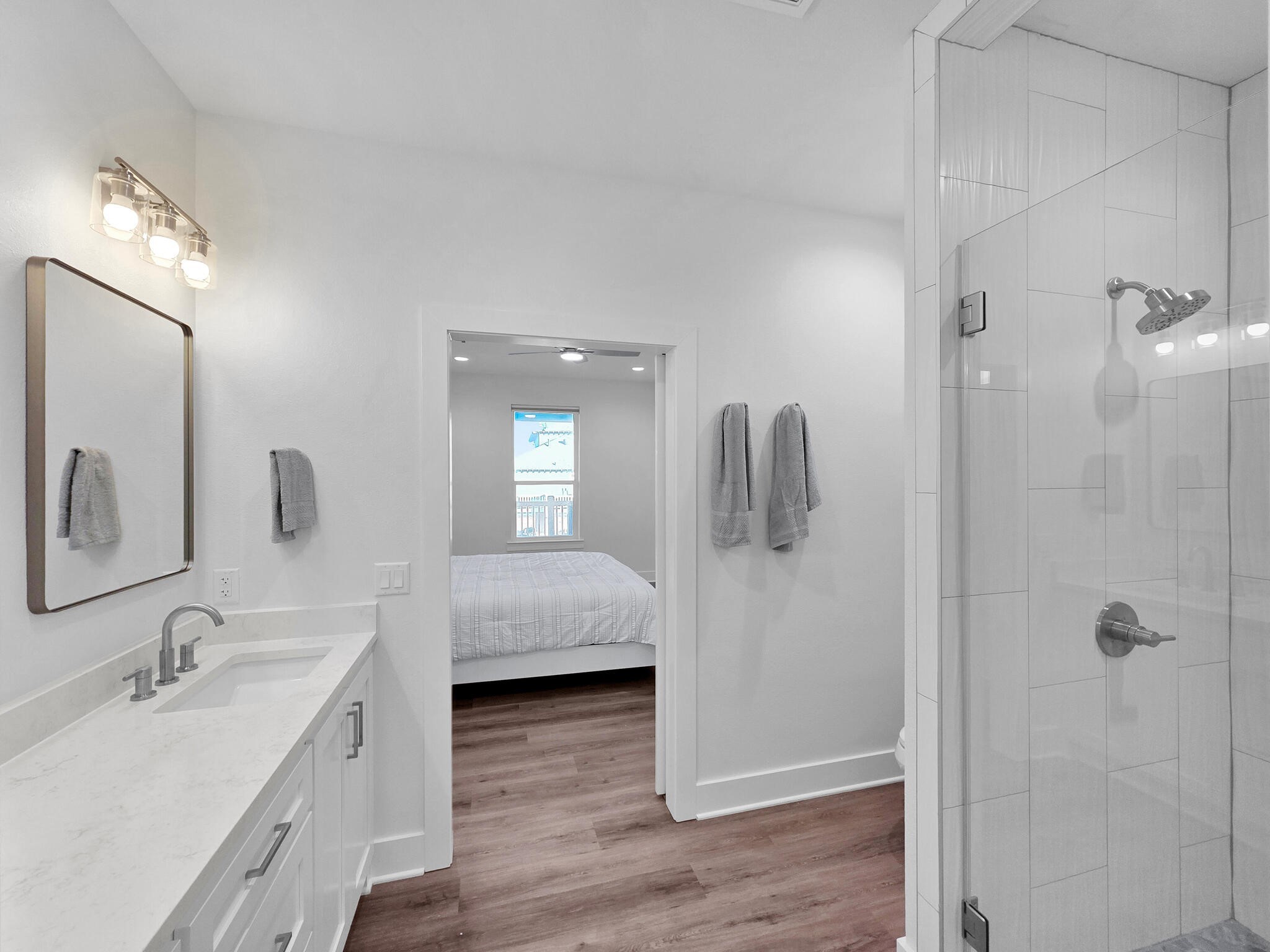 1221 Gulf Road Crystal Beach, TX 77650 - Photo 28 of 48 a en suite bathroom with a granite countertop sink a mirror and shower