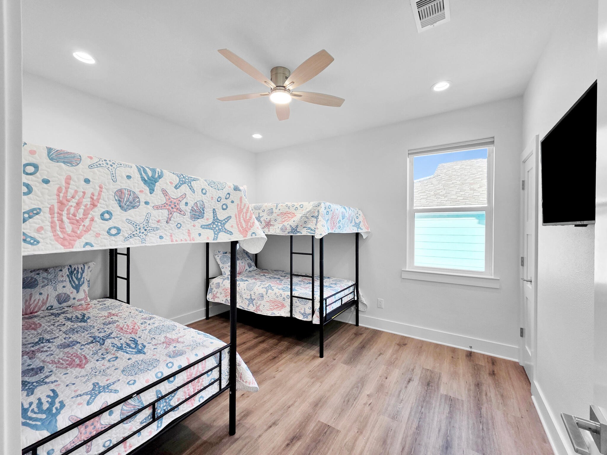 1221 Gulf Road Crystal Beach, TX 77650 - Photo 29 of 48 a bedroom with a bed and a flat screen tv