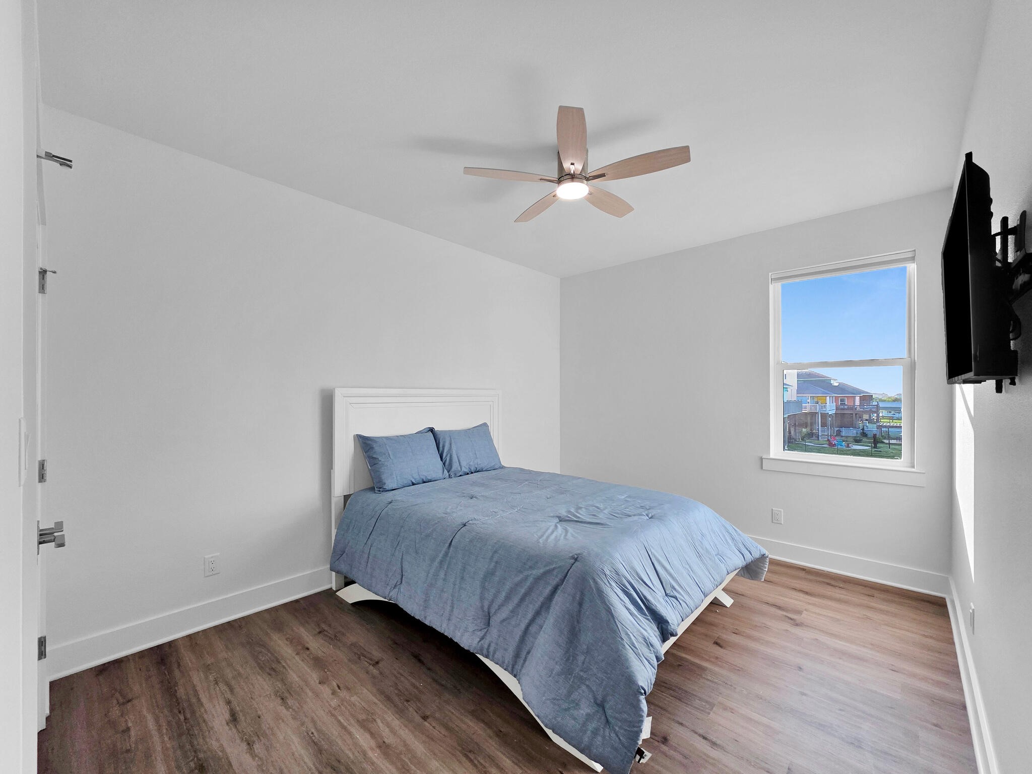 1221 Gulf Road Crystal Beach, TX 77650 - Photo 31 of 48 a bedroom with a bed and a flat screen tv