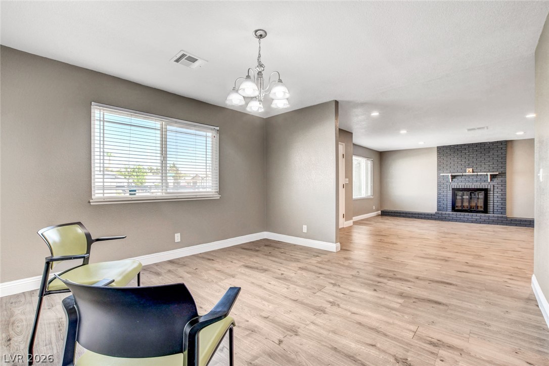 4367 South Mojave Road Las Vegas, NV 89121 - Photo 13 of 53 A spacious room features light wood flooring, a fireplace, and generous natural light from broad windows.