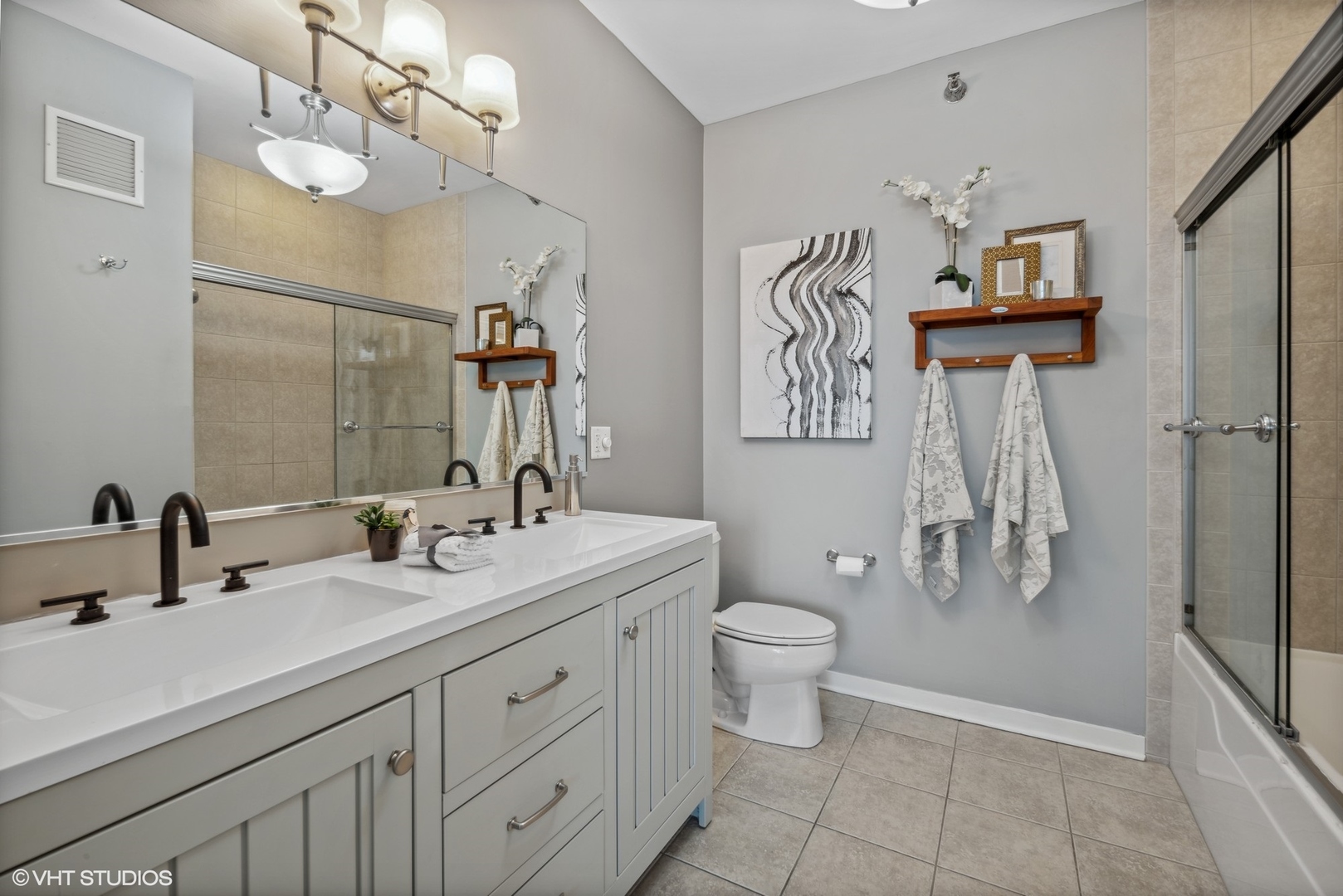 757 North Orleans Street, Unit 1111 Chicago, IL 60654 - Photo 12 of 16 a bathroom with a double vanity sink mirror and toilet