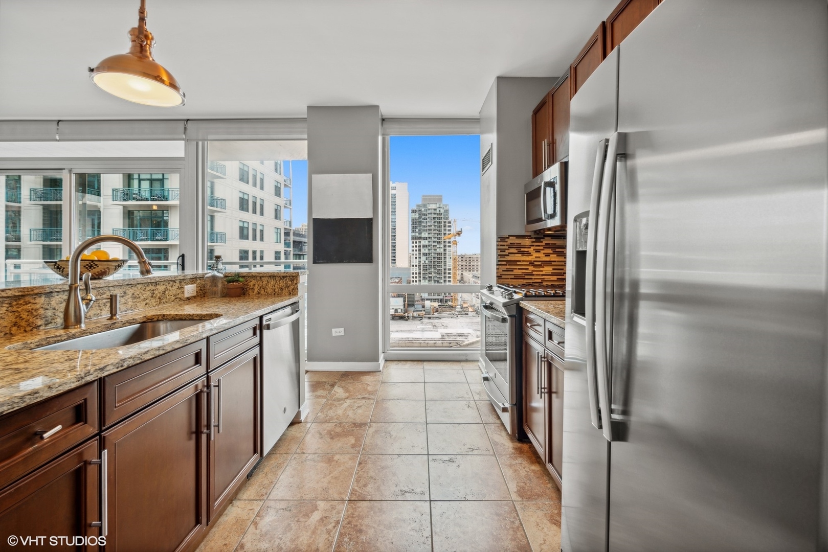 757 North Orleans Street, Unit 1111 Chicago, IL 60654 - Photo 6 of 16 a kitchen with stainless steel appliances granite countertop a refrigerator and a sink