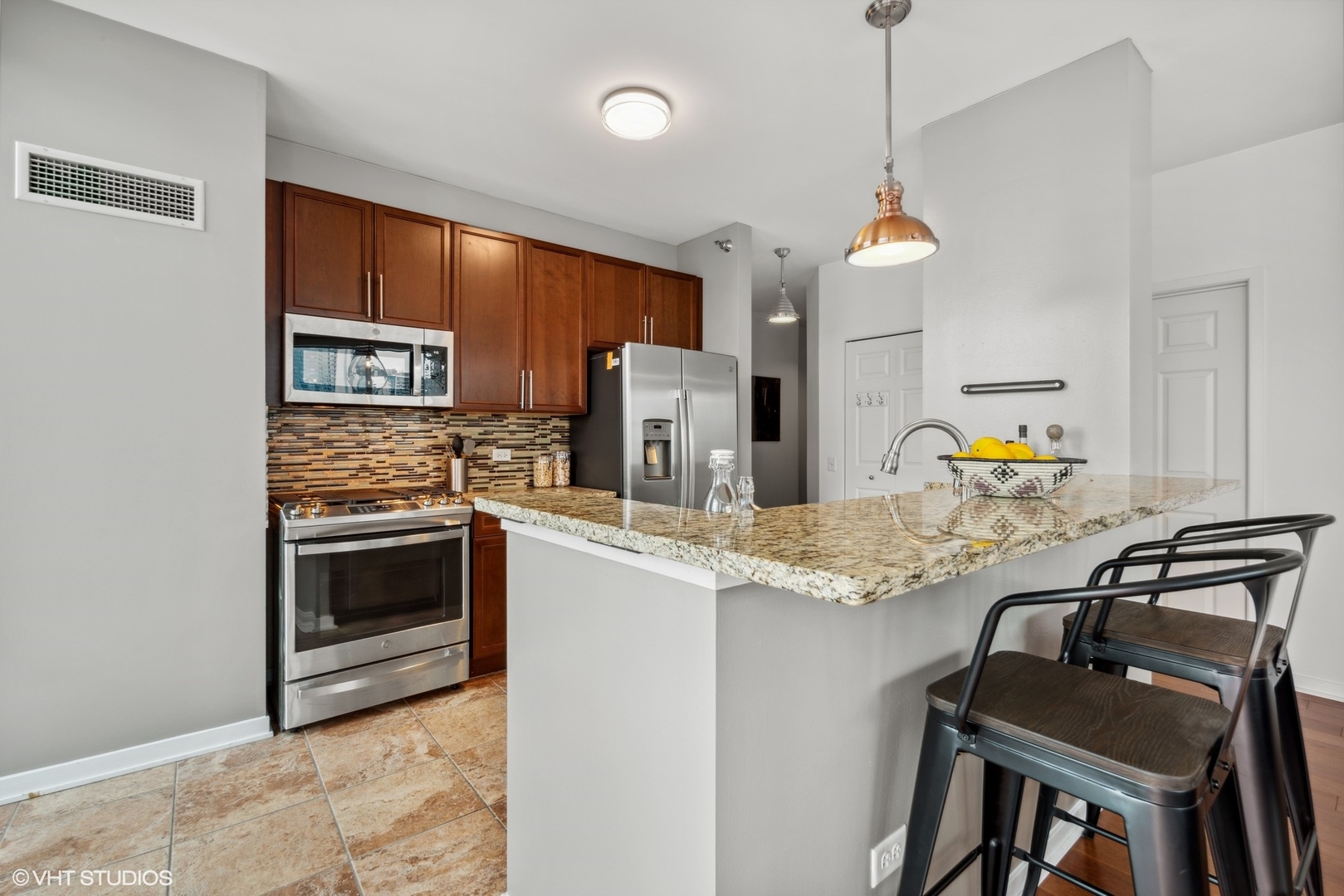 757 North Orleans Street, Unit 1111 Chicago, IL 60654 - Photo 7 of 16 a kitchen with a stove a sink and a refrigerator