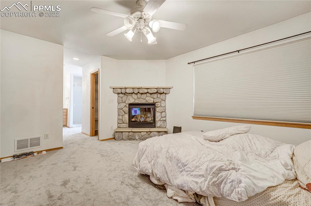 9155 Morgan Road Colorado Springs, CO 80908 - Photo 17 of 41 a large bed with a fireplace in it