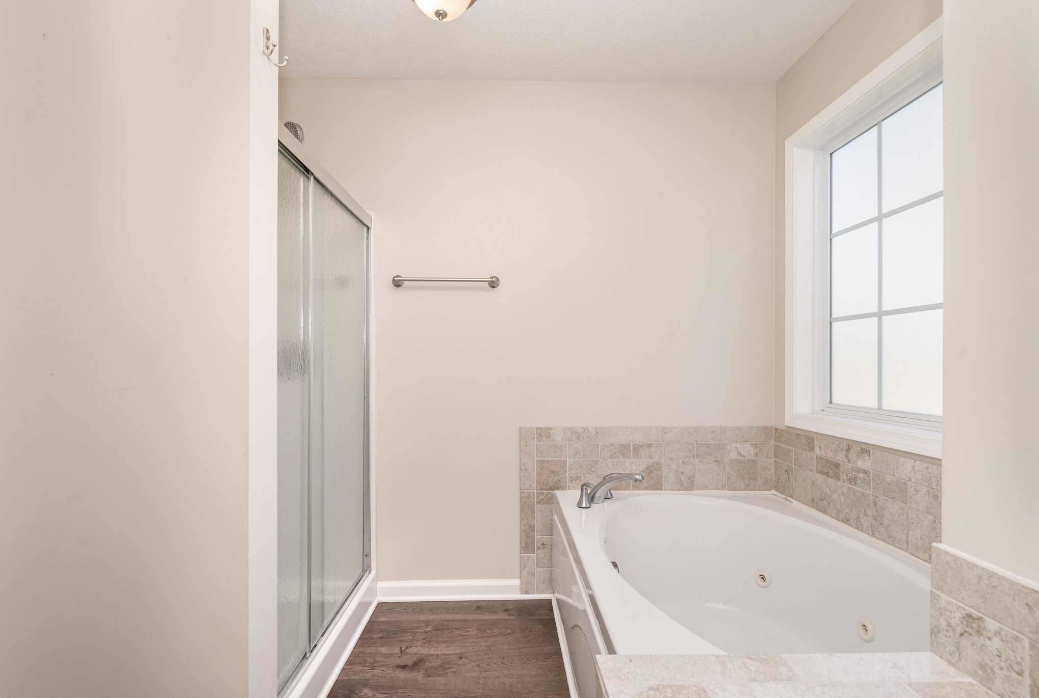 3773 Atkins Road Cedar Hill, TN 37032 - Photo 17 of 29 a bathroom with a bathtub and window