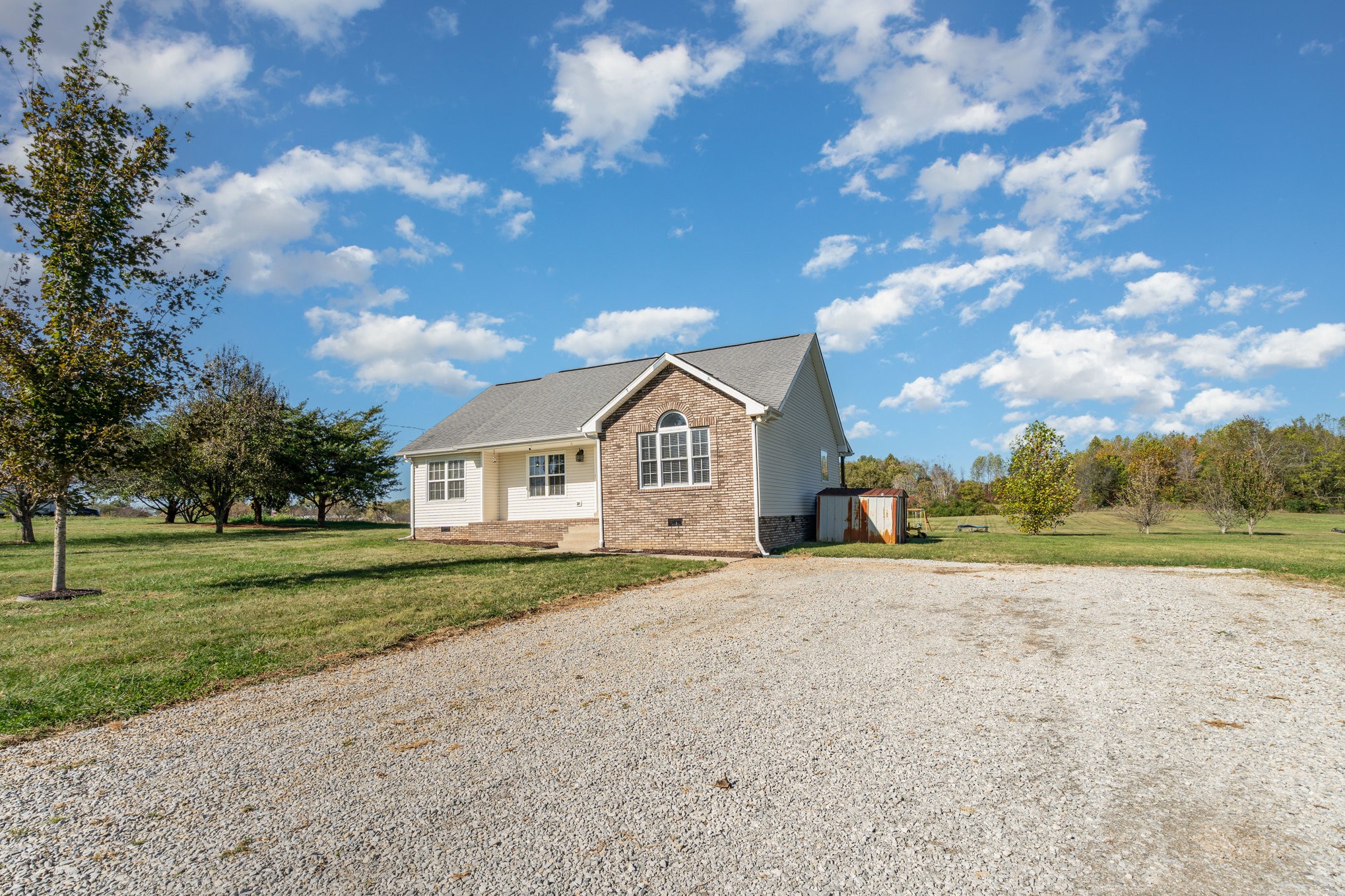 3773 Atkins Road Cedar Hill, TN 37032 - Photo 2 of 29 a front view of a house with a yard and garage