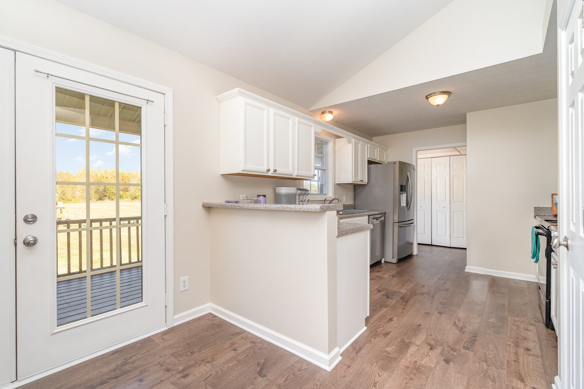 3773 Atkins Road Cedar Hill, TN 37032 - Photo 8 of 29 a kitchen with a refrigerator a sink and a cabinets
