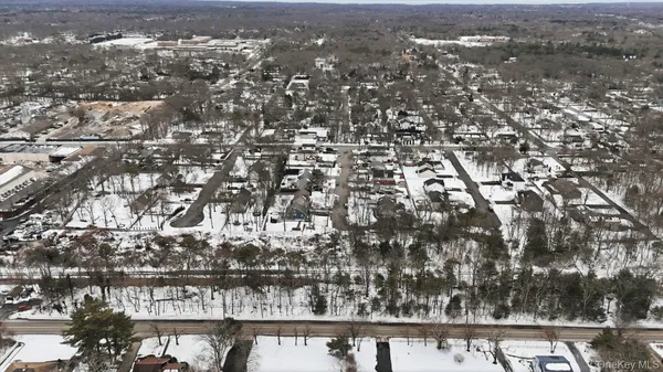 an aerial view of residential building with trees in background